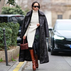 woman wearing sweater dress, coat and boots