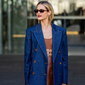 woman wearing blue blazer and brown dress