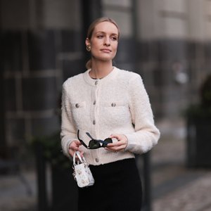 woman wearing white cardigan and black pants