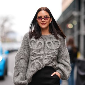 woman wearing gray sweater in streets