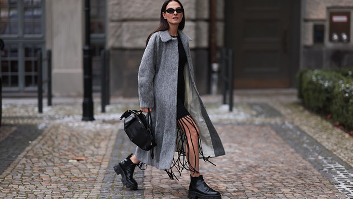 woman wearing gray coat and black boots