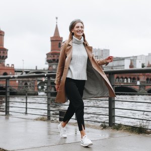 Young woman walking by river in Berlin, Germany