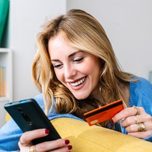 woman online shopping with credit card and phone