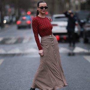 woman wearing red top and beige maxi skirt
