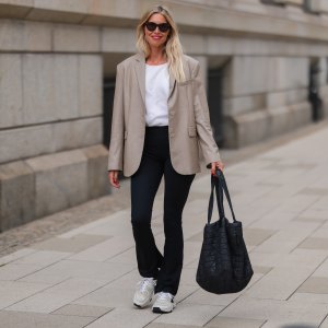 woman in beige blazer and black leggings