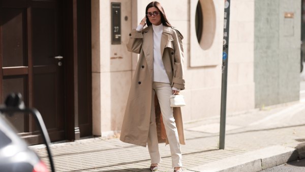 woman wearing beige coat, white sweater and cream pants