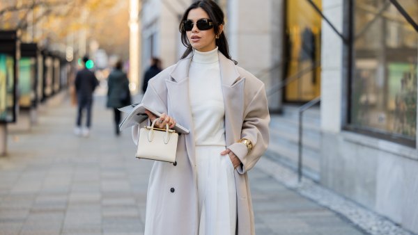 Bella Emar wears oversized grey double breasted sourceunknown coat, creme white turtleneck top Zara, white wide leg pants Frankie Shop, strathberry bag on November 30, 2024 in Berlin, Germany.