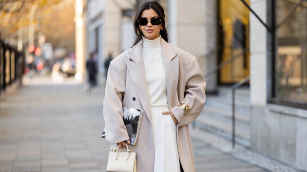 Bella Emar wears oversized grey double breasted sourceunknown coat, creme white turtleneck top Zara, white wide leg pants Frankie Shop, strathberry bag on November 30, 2024 in Berlin, Germany.