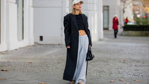 BERLIN, GERMANY - NOVEMBER 30: Sophia Geiss wears Cap Opera Sports, shirt other stories, black coat Herskind, grey sweatpants Mo&co, bag Cos, boots Ugg on November 30, 2024 in Berlin, Germany. (Photo by ChristiSan Vierig/Getty Images)
