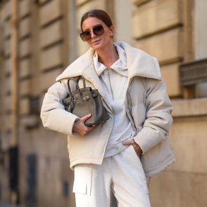 PARIS, FRANCE - OCTOBER 23: Diane Batoukina wears black Dior sunglasses, a white Varley puffer jacket, a white Adidas sweatshirt, white Varley pants, a grey leather Birkin Hermes bag, white socks, white Samba Adidas sneakers shoes, during a street style fashion photo session, on October 23, 2024 in Paris, France. (Photo by Edward Berthelot/Getty Images)