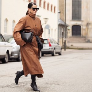COPENHAGEN, DENMARK - JANUARY 31: Gili Biegun wears, long brown leather coat, black bag, black long leather gloves, sunglasses and black shoes during the Copenhagen Fashion Week Autumn/Winter 2025 on January 31, 2025 in Copenhagen, Denmark. (Photo by Raimonda Kulikauskiene/Getty Images)