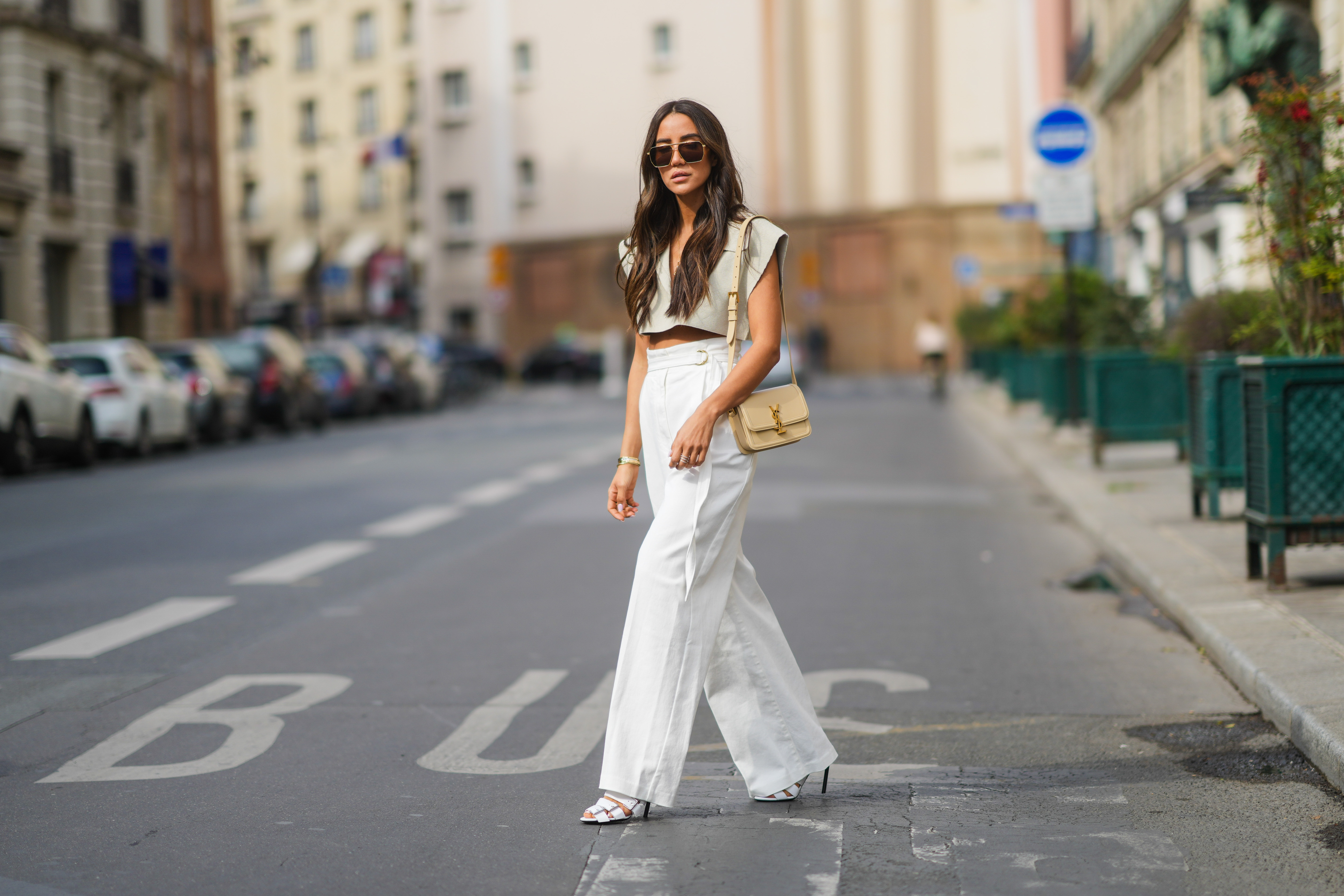 woman wearing cropped beige blouse and white pants