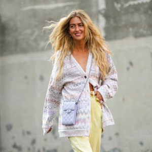 woman wearing purple cardigan and yellow pants