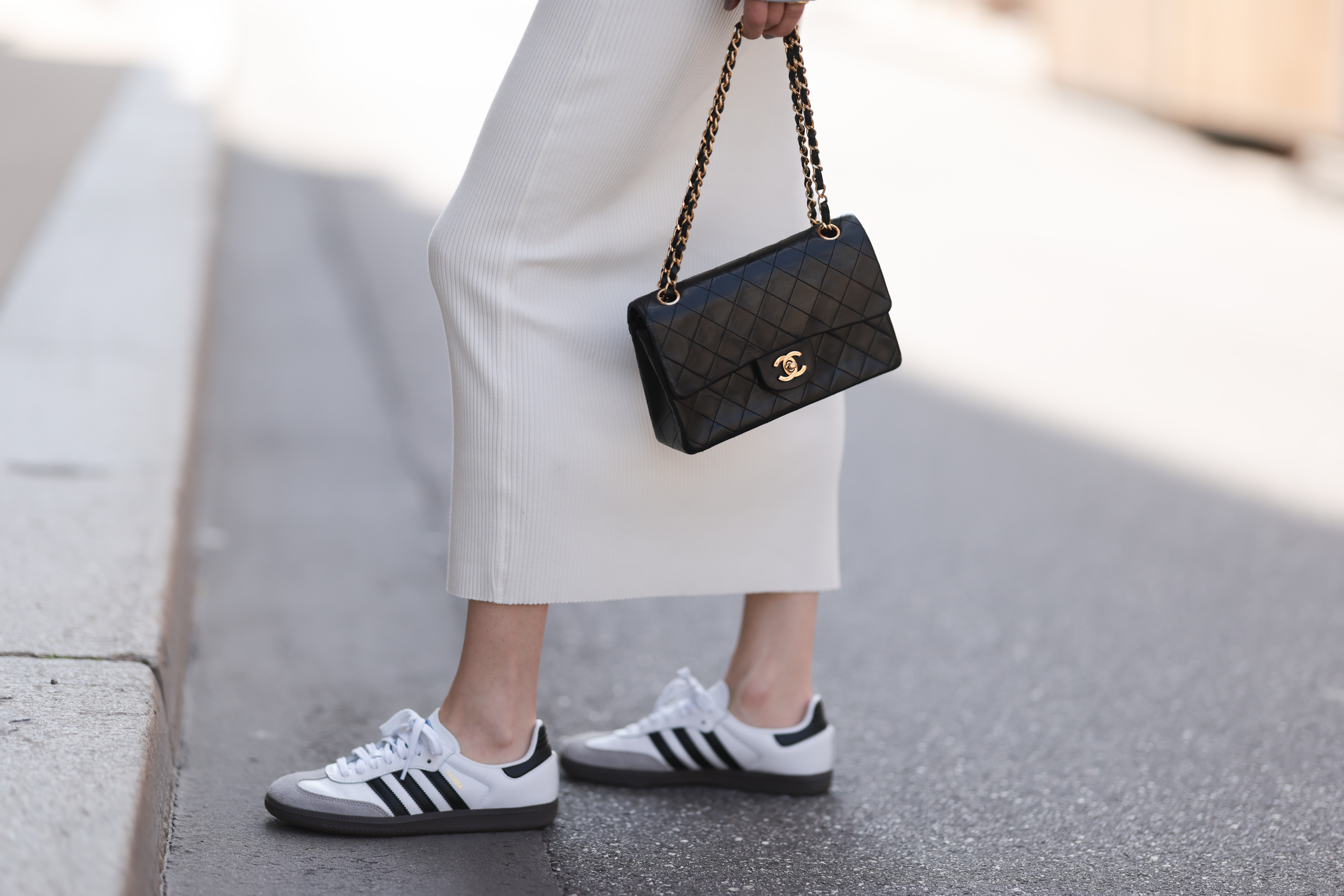 woman wearing adidas sneakers and Chanel bag