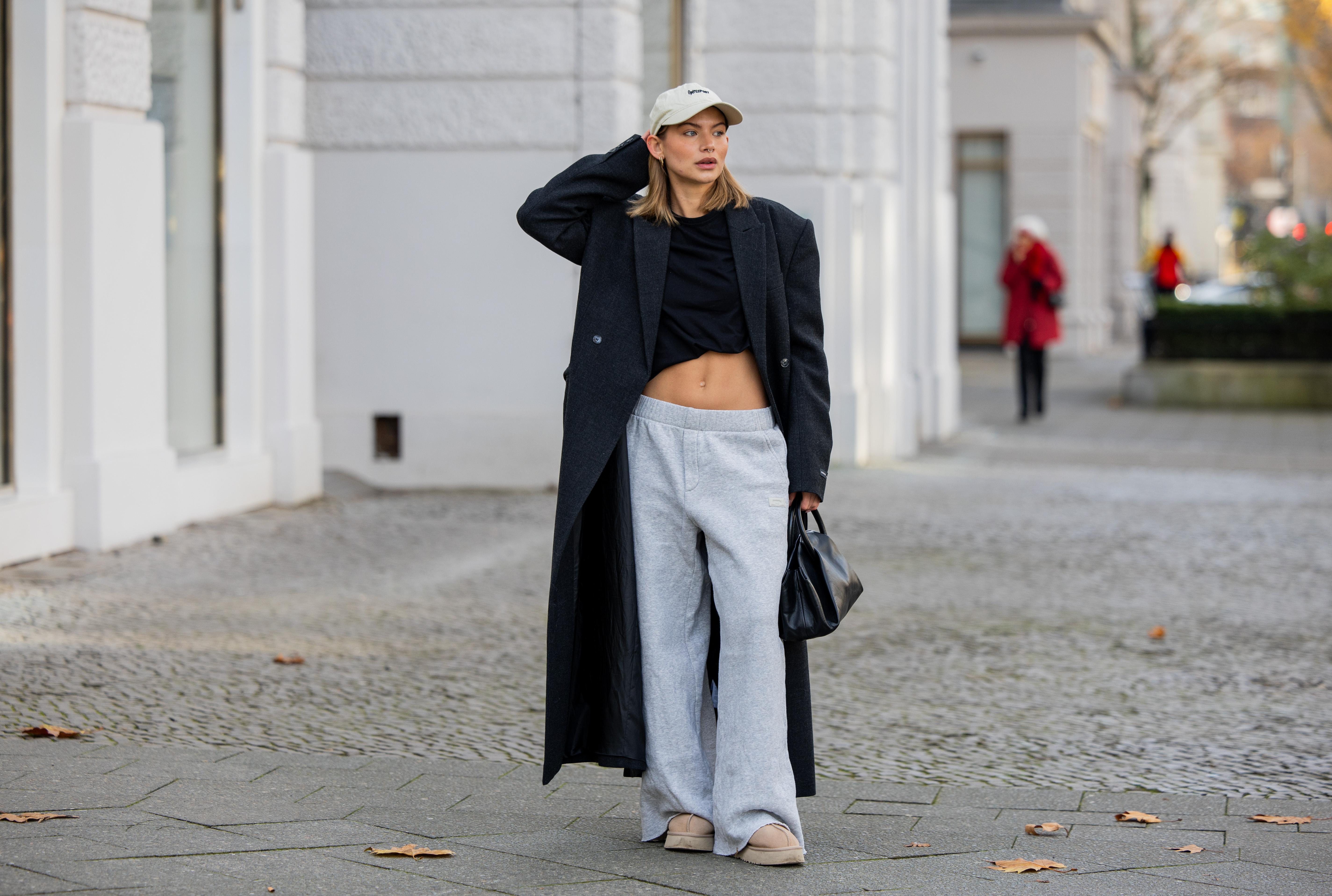woman wearing sweatpants and trench coat