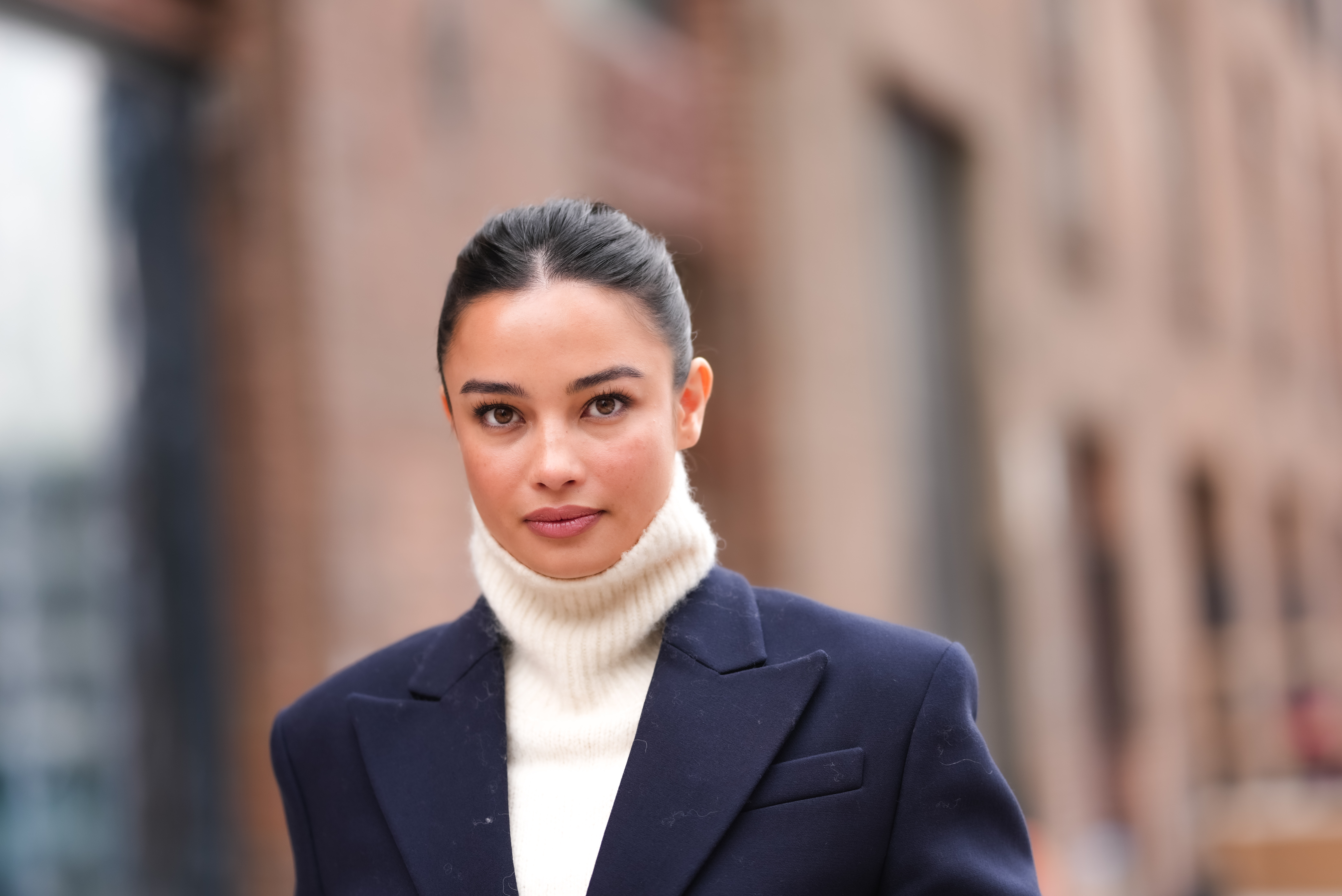 woman wearing white sweater and navy blazer