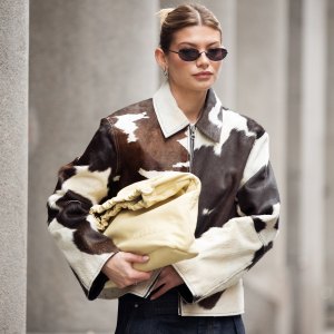 COPENHAGEN, DENMARK - JANUARY 30: Sophia Geiss wears cow print cropped jacket with a zipper, pale yellow bag, blue wide jeans during the Copenhagen Fashion Week Autumn/Winter 2025 on January 30, 2025 in Copenhagen, Denmark. (Photo by Raimonda Kulikauskiene/Getty Images)