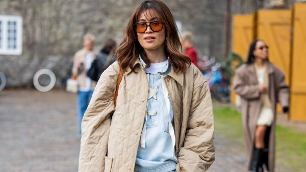 COPENHAGEN, DENMARK - JANUARY 30: Michelle Elie wears wide leg blue pants, beige jacket, top outside Munthe during the Copenhagen Fashion Week Autumn/Winter 2025 on January 30, 2025 in Copenhagen, Denmark. (Photo by Christian Vierig/Getty Images)