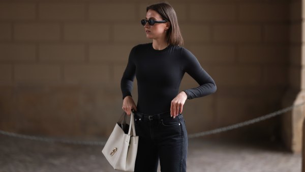 BERLIN, GERMANY - FEBRUARY 25: Marie Danker seen wearing Carolina Lemke black oval sunglasses, diamond earrings, Arket black straight leg denim jeans pants, Skims black body, black leather belt, Furla white leather bag, on February 25, 2023 in Berlin, Germany. (Photo by Jeremy Moeller/Getty Images)