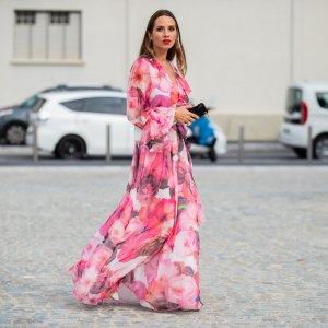 Maria Rosaria Rizzo is seen wearing a pink dress with floral print MSGM, white Furla fanny belt bag, Jonak boots during Milan Fashion Week Spring/Summer 2020 on September 18, 2019 in Milan, Italy.