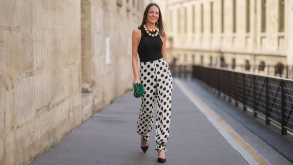 woman in black and white polka dotted pants, top and heels
