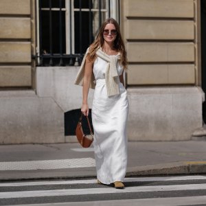 woman wearing white outfit and beige sweater