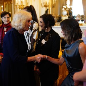 Victoria Beckham curtsies to Queen Camilla