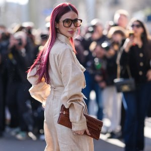 PARIS, FRANCE - MARCH 08: Heart Evangelista wears burgundy bordeaux hair, dark brown sunglasses, cream cargo belted Elie Saab Cut-Out Cady jumpsuit, dark brown clutch leather bag, outside Elie Saab, during the Paris Fashion week Women's Fall/Winter 2025-2026 on March 8, 2025 in Paris, France. (Photo by Edward Berthelot/Getty Images)