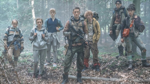 A group of teens stand in the woods in The Rain.