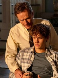 A man stands over a boy tied to a chair in 'Your Honor.'
