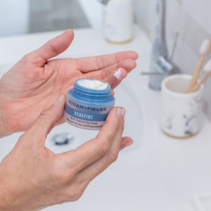 A woman's hands holding cream