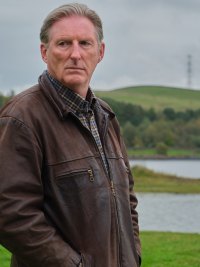 A man stands in a field in Ridley.
