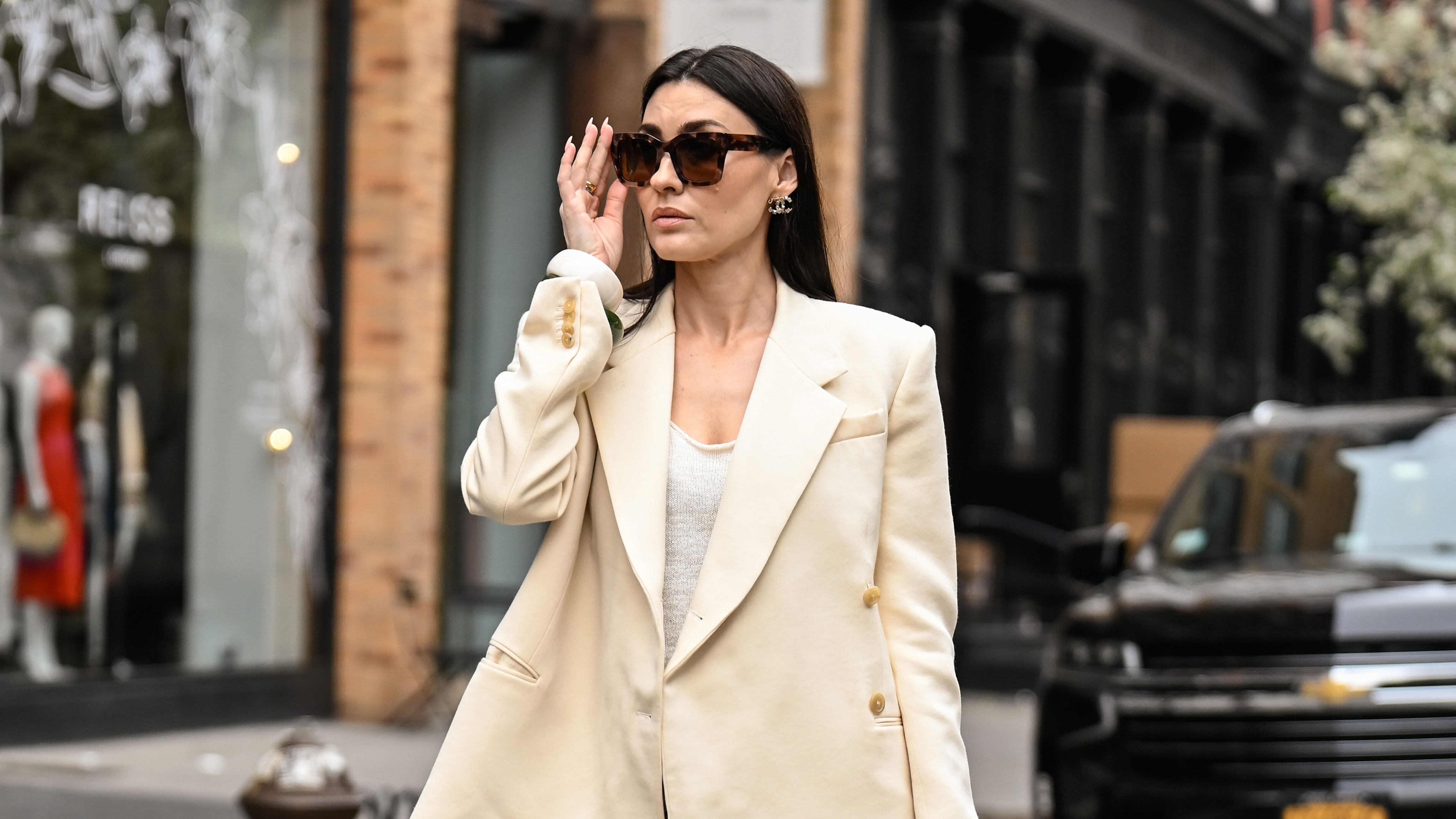 NEW YORK, NEW YORK - APRIL 15: Yana Echko is seen wearing a Khaite blazer, Zara top, Dries Van Noten skirt, Chanel bag, Chanel earrings, Warby Parker sunglasses, KOZAKH rings, Lola and Rose rings and Zara bracelets on April 15, 2025 in New York City. (Photo by Daniel Zuchnik/Getty Images)