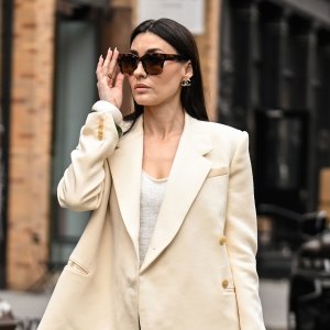NEW YORK, NEW YORK - APRIL 15: Yana Echko is seen wearing a Khaite blazer, Zara top, Dries Van Noten skirt, Chanel bag, Chanel earrings, Warby Parker sunglasses, KOZAKH rings, Lola and Rose rings and Zara bracelets on April 15, 2025 in New York City. (Photo by Daniel Zuchnik/Getty Images)
