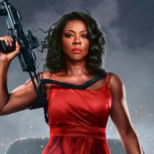 Viola Davis holds a gun while wearing a red dress in G20.