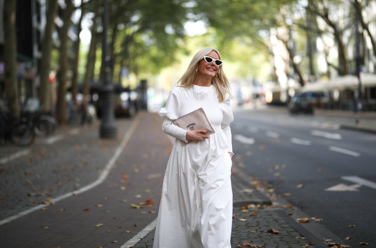 Judith Mosqueira do Amaral wearing Toteme dress, Ariane Ernst earring, Balenciaga sneaker, Hermes clutch and Celine shades on August 14, 2020 in Cologne, Germany.
