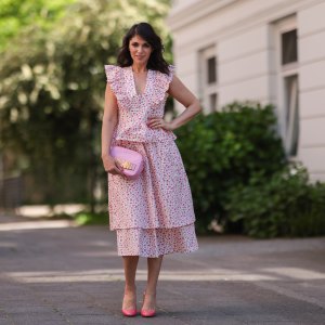 Anna Wolfers wearing white and pink ruffle dress via Goldig Shop, pink Moschino clutch and pink heels on May 31, 2021 in Hamburg, Germany.