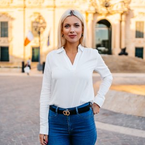 Portrait of a beautiful young blonde woman on the town square in Valletta, Malta.