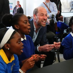 Prince William playing computer games with kids