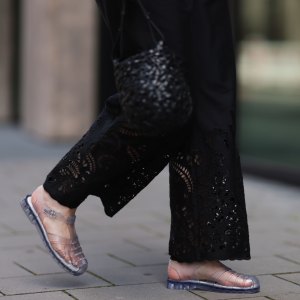 BERLIN, GERMANY - JULY 28: Maria Barteczko seen wearing ARKET black embroidered wide leg trousers, LOEWE black handwoven Nest basket bag and Melissa Possession transparent Jelly fisherman sandals, on July 28, 2024 in Berlin, Germany. (Photo by Jeremy Moeller/Getty Images)