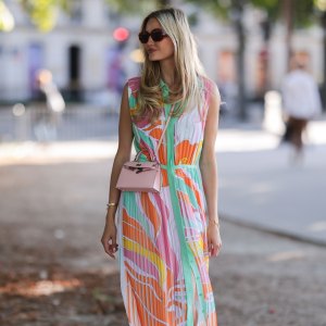 PARIS, FRANCE - JULY 06: Mandy Bork seen wearing brown sunglasses from Tom Ford, a colorful buttoned / pleated / sleeveless long dress from Emilio Pucci, a pale pink Hermes Kelly mini bag and white creme sandals from Chanel, during Paris Fashion Week - Haute Couture Fall Winter 2022 2023, on July 06, 2022 in Paris, France. (Photo by Jeremy Moeller/Getty Images)