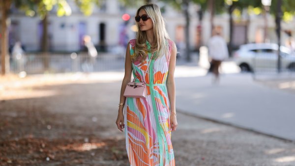 PARIS, FRANCE - JULY 06: Mandy Bork seen wearing brown sunglasses from Tom Ford, a colorful buttoned / pleated / sleeveless long dress from Emilio Pucci, a pale pink Hermes Kelly mini bag and white creme sandals from Chanel, during Paris Fashion Week - Haute Couture Fall Winter 2022 2023, on July 06, 2022 in Paris, France. (Photo by Jeremy Moeller/Getty Images)