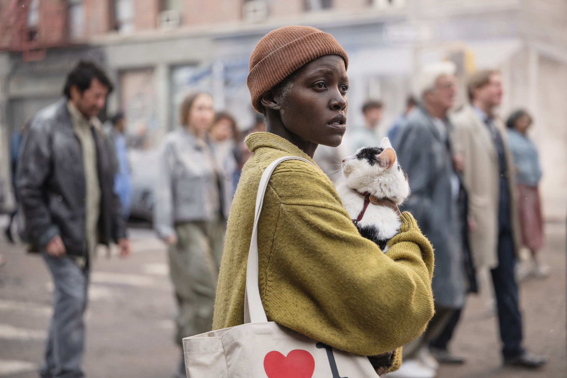 A woman holds a cat in A Quiet Place: Day One.