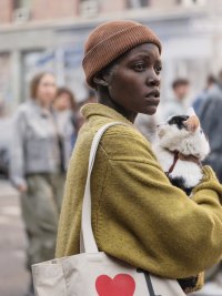A woman holds a cat in A Quiet Place: Day One.