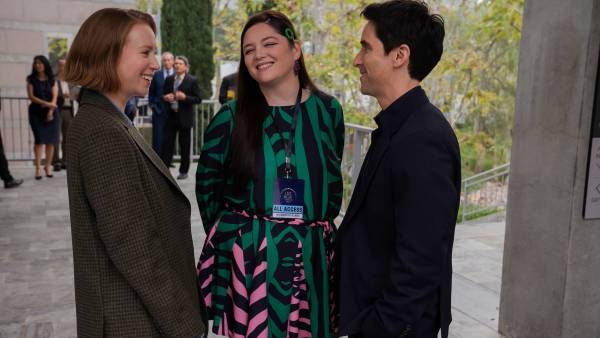 Three people stand and talk in Hacks season 4.