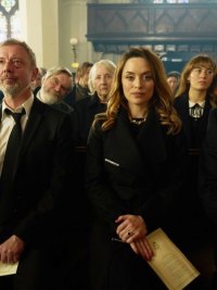 Mourners stand in a church in 'I, Jack Wright.'