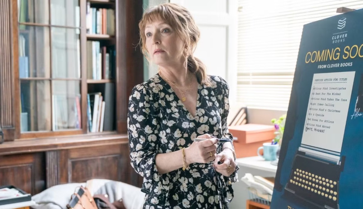 A woman looks away from a presentation in Magpie Murders.