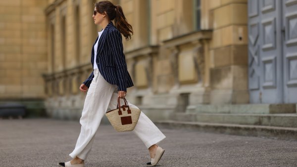 Cleo zu Oettingen-Spielberg wearing navy blue striped Polo Ralph Lauren jacket, white polo and white linen pants and beige Loewe bag via Lodenfrey SS21 on May 10, 2021 in Munich, Germany.