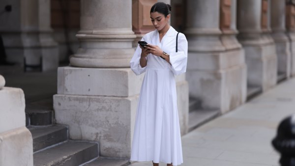 LONDON, ENGLAND - SEPTEMBER 18: Ambika Dhir was seen wearing black leather ballerinas, a black bag, a yellow gold and black Yve Saint Laurent bracelet as well as a white dress with collar before Emilia Wickstead Fashion Show during London Fashion Week September 2023 at the on September 18, 2023 in London, England. (Photo by Jeremy Moeller/Getty Images)