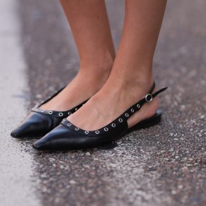 COPENHAGEN, DENMARK - AUGUST 05: A Fashion Week guest is seen wearing pointed black leather flats with silver eyelets from Aeyde before Rotate x Vogue Breakfast during the Copenhagen Fashion Week (CPHFW) SS25 on August 05, 2024 in Copenhagen, Denmark. (Photo by Jeremy Moeller/Getty Images)